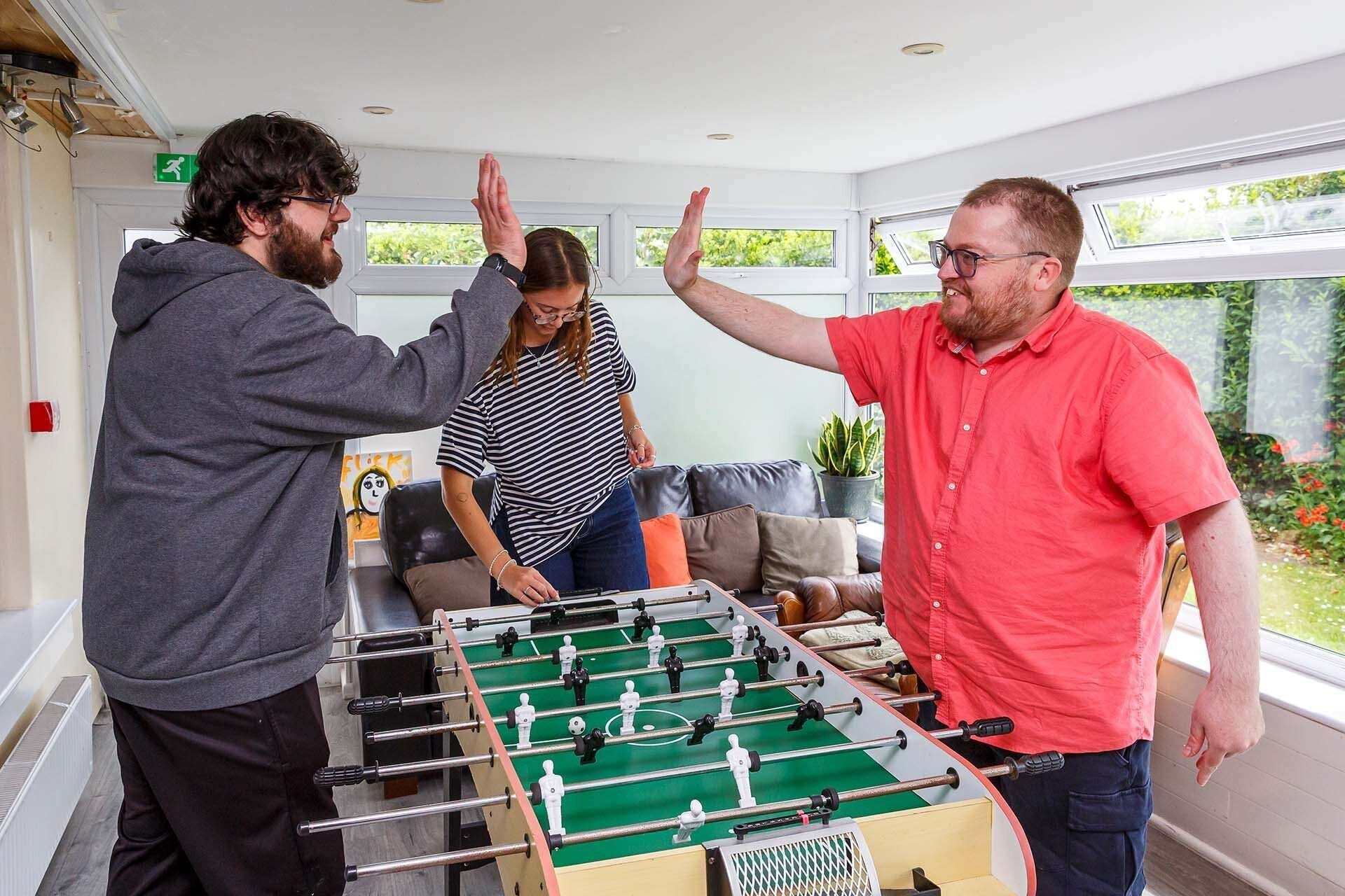 Support Match workers high-fiving with participants